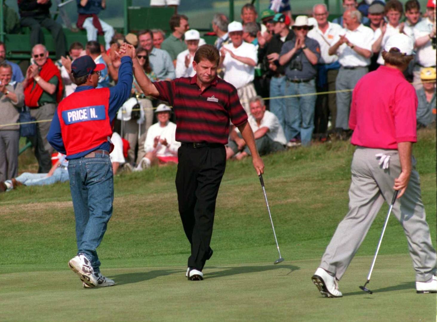 Nick Price celebrates with his caddie after making eagle on the 17th on the final round at Turnberry in 1994